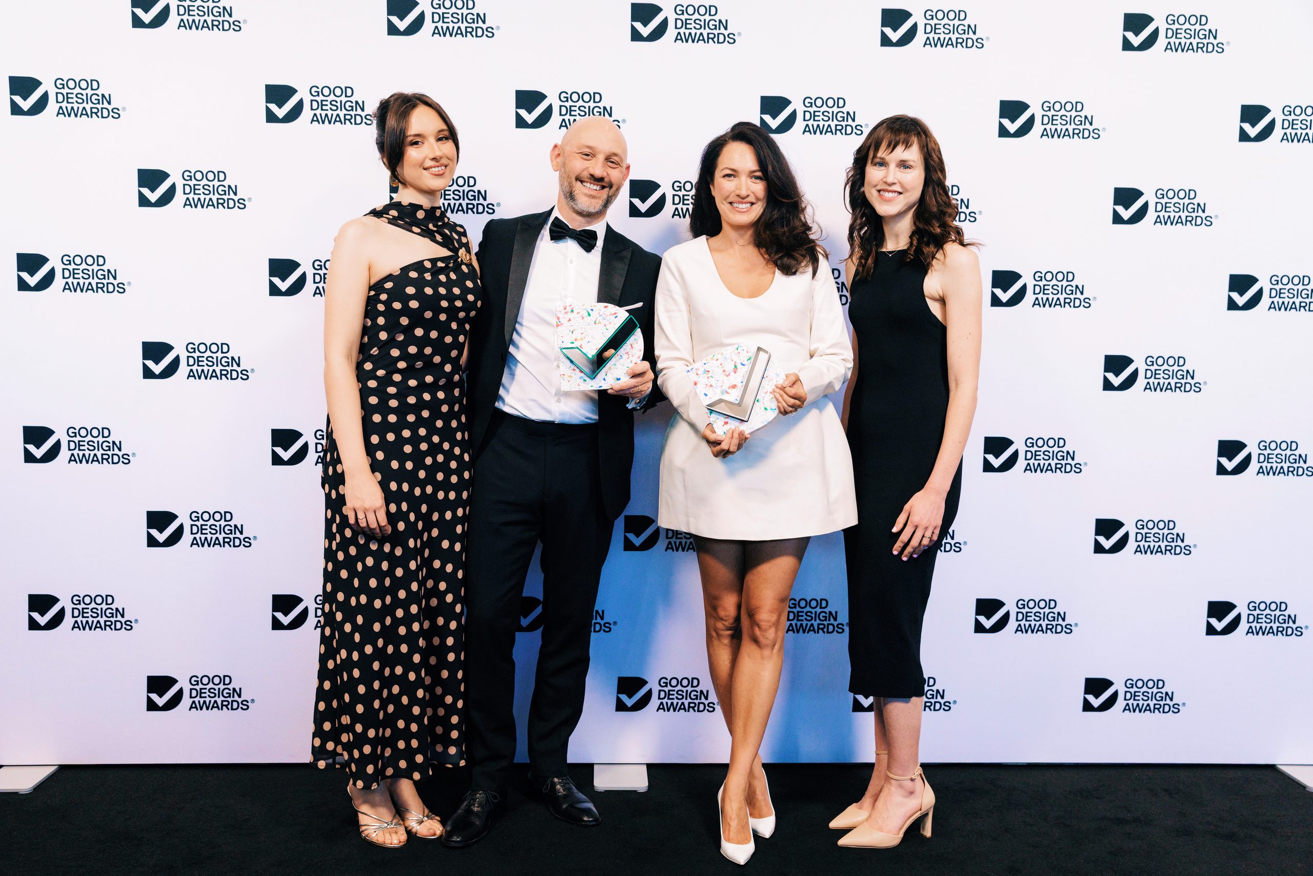 The Oliver Grace team holding their two Good Design Awards at ICC Sydney.